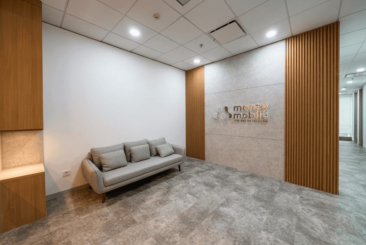 Minimalist modern office reception design — wood-slat feature wall, Monty Mobile